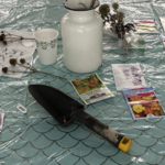 trowel and seed packages on a blue oil cloth